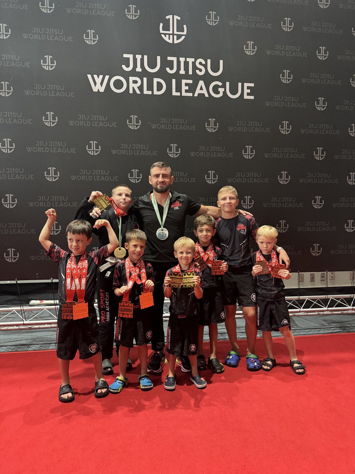 Youth martial arts athletes with their coaches after competition